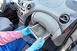 Replacement of cabin pollen air filter for a car. Basic auto mechanic skills concept.