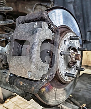 Replacing brake pads and discs in a car on a lift at a service center