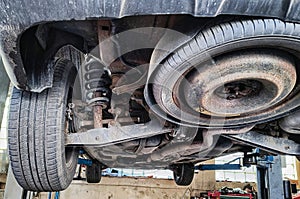 Replacing brake pads and discs in a car on a lift at a service center