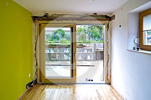 Replacing brick wall with glass sliding door in residential house.