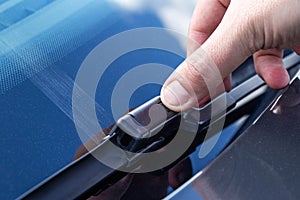 Replacing a car windshield wiper wiper with graphic coating wipers, close-up