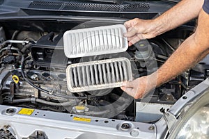 Replacing the dirty engine air filter for a car