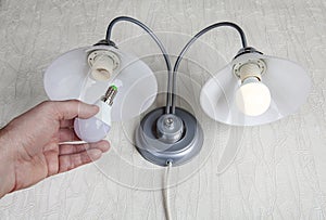 Replacing electric lightbulbs in household wall lamp, LED light bulb