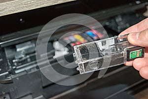 Replacing the ink in the printer  the human hand takes out the cartridge