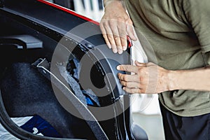 Replacing spare parts on a disassembled car in a car service garage