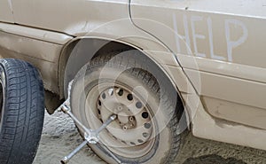 Replacing a wheel on a car on the road. Repair assistance on the go.