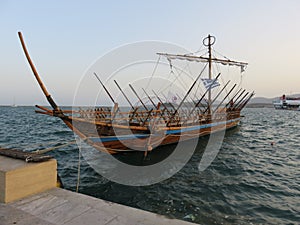 Replica of an ancient ship at harbor