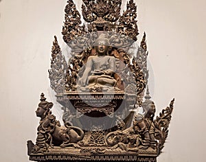 Replica of Buddha idol on Salin Monastery gateway copper structure.