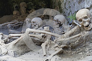 Replica skeletons in the position that the bodies were found after volcanic flow in 79AD Herculaneum