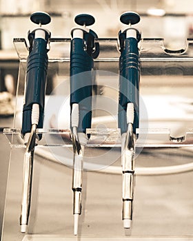 Replicating pipettes on a stand in a research lab. photo