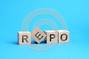 repo - text on wooden blocks, business concept, blue background