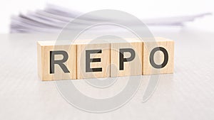 repo word written on wood cubes with white background