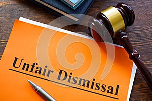 Report about unfair dismissal with book on the table.