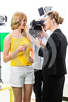 Reporter and cameraman shoot an interview