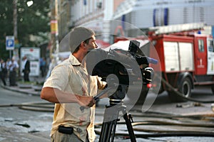 The reporter reports on the fire in the building from the scene