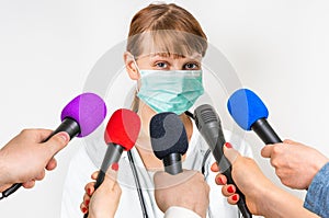 Reporters making interview with female doctor photo