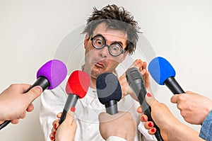 Reporters making interview with funny scientist photo