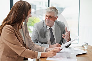 The reports show that weve had our best quarter yet. Shot of two businesspeople having a meeting in an office.