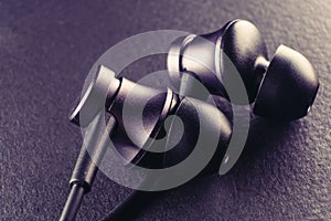 A representation of the youth culture, sport and modern technology, as a pair of earbuds on a black background symbolize