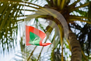 Republic of Maldives red green colour national flag on the rope during beautiful windy day