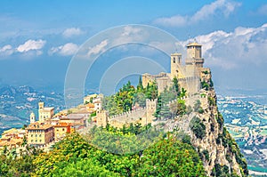Republic San Marino Prima Torre Guaita first fortress tower with brick walls on Mount Titano stone rock with green trees