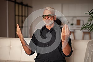 Request for forgiveness, help. Senior man praying to god at home
