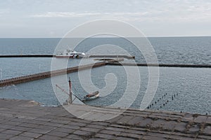 Rescue boat in old marine with crane in winter time of Azov sea