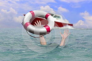 Rescue boat using life buoy trying to save drowning person at sea