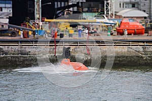 Rescue boat with water splashes in the sea for load testing or lifeboat at shipyard