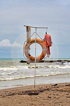 Rescue equipment on the water, lifebuoy and life jacket on the beach