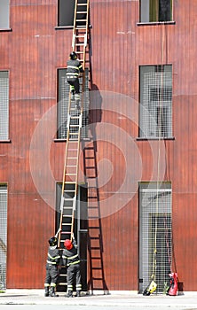 rescue exercises with the ladder and firefighters in firehouse