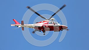 Rescue helicopter flies fast in the blue sky