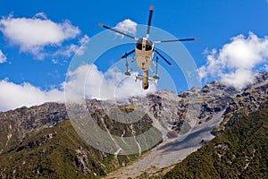 Rescue helicopter fly over mountainous wilderness