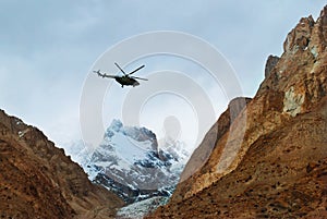 Rescue helicopter flying under mountains in Pakistan