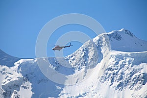 Rescue helicopter over a mountain ridge