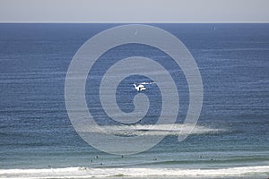 Rescue Helicopter pulling surfer up from ocean waves