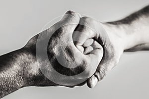 Rescue, helping hand. Male hand united in handshake. Man help hands, guardianship, protection. Black and white