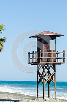 rescue hut on a sandy beach, safe relax by the ocean, a beautiful sunny day