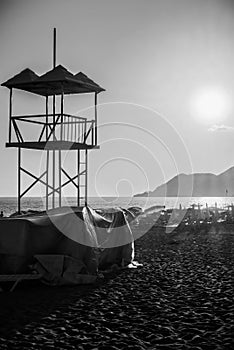 Rescue lifeguard tower sea ocean sandy beach at sunset in evening