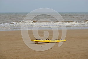 Rescue surfboard on sand beach