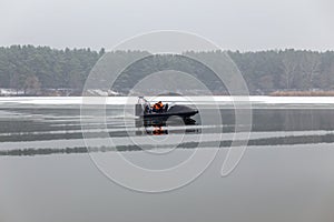 A rescue team is sailing on a hovercraft to rescue fishermen on the ice