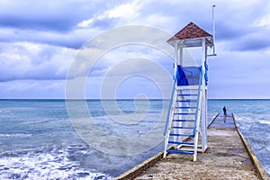 Rescue tower on the shore of a stormy sea