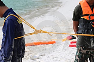 Rescue training to help the victims with a rope on the beach fo