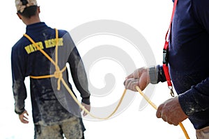 Rescue training to help the victims with a rope on the beach fo