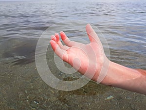 rescue on the water .a hand sticks out of the water. a drowning man asks for help.