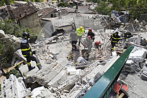 Rescue workers on rubble after earthquake, Pescara del Tronto, Italy