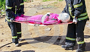 Rescuers carry on a stretcher photo