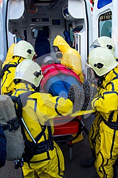 Rescuers in chemical and biological protection suit rescue the injured