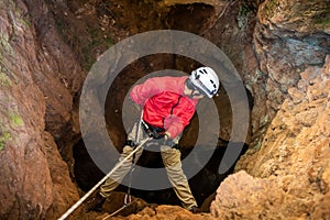 Rescuers or climber descends in a cave fast rope photo