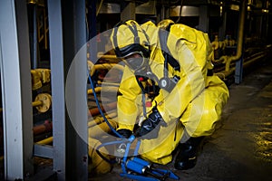 Rescuers in a radiation protection suit